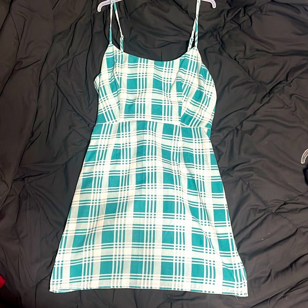 A green and white mini dress. Spaghetti straps and is plaid.